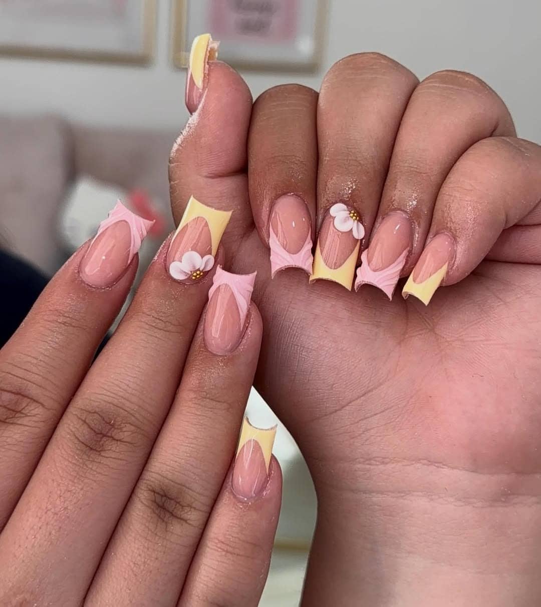 6. Pastel Yellow French Tip Nails with Floral Accent - short square nail ideas