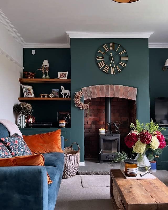 7. Dark Green Cottage Living Room with Brick Fireplace - dark green living room ideas