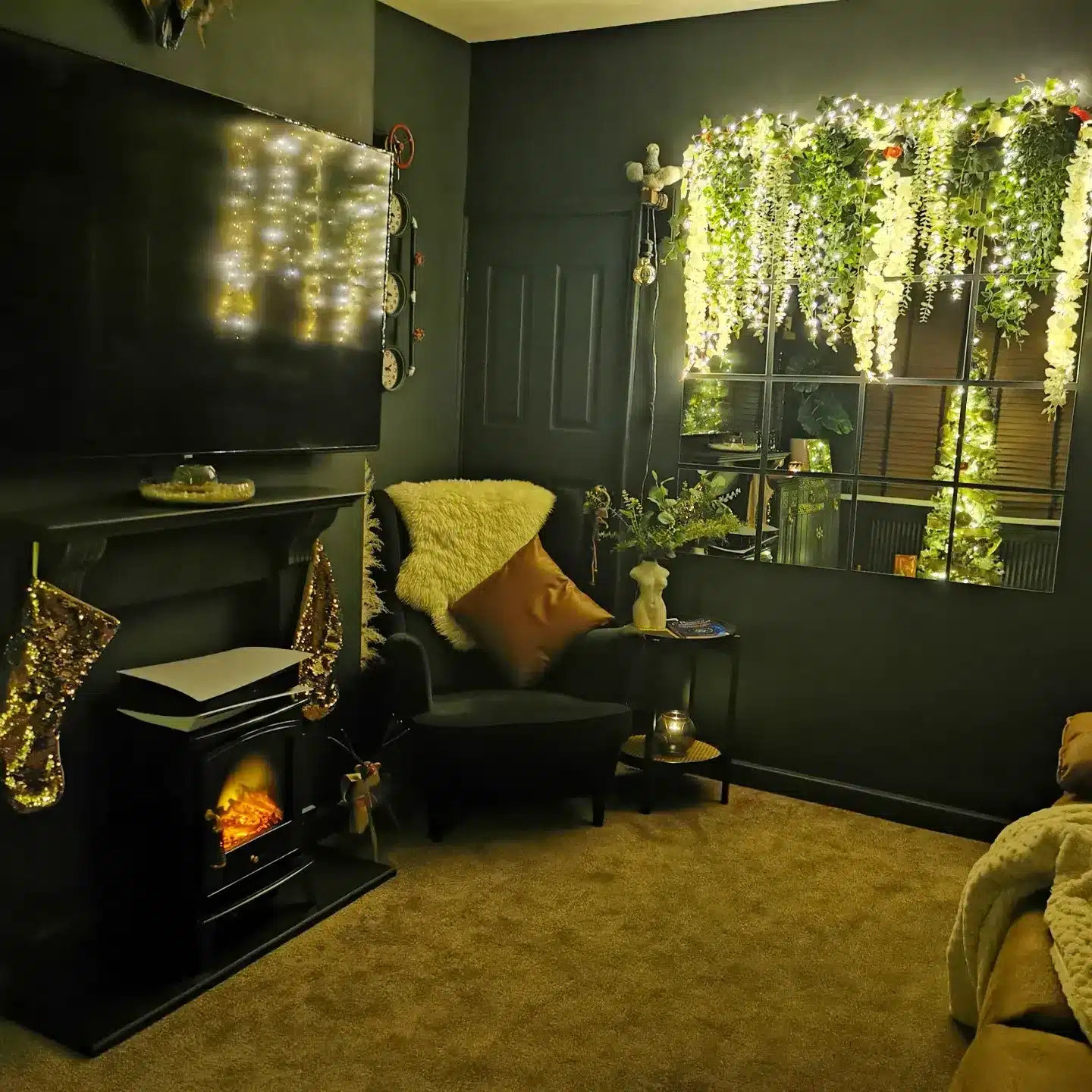11. Dark Green Living Room with Fairy Lights and Cozy Fireplace - dark green living room ideas