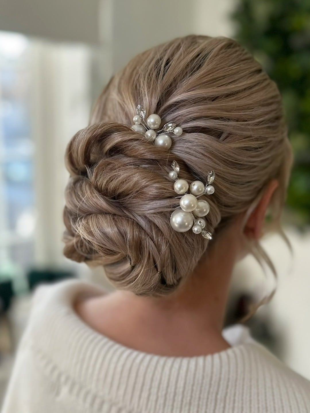 6. Pearl-Accented Ash Blonde Bridal Low Bun - Wedding Hairstyles
