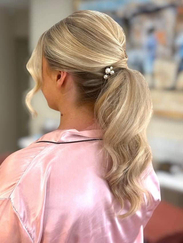 8. Soft Blonde Low Ponytail with Pearl Clip - Wedding Hairstyles