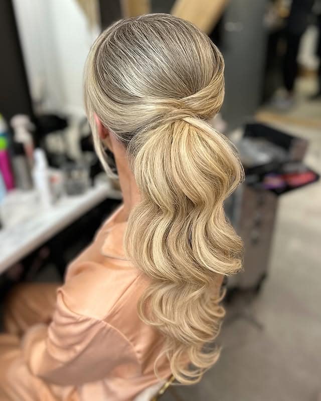 19. Ash Blonde Sleek Low Ponytail with Soft Waves - Wedding Hairstyles