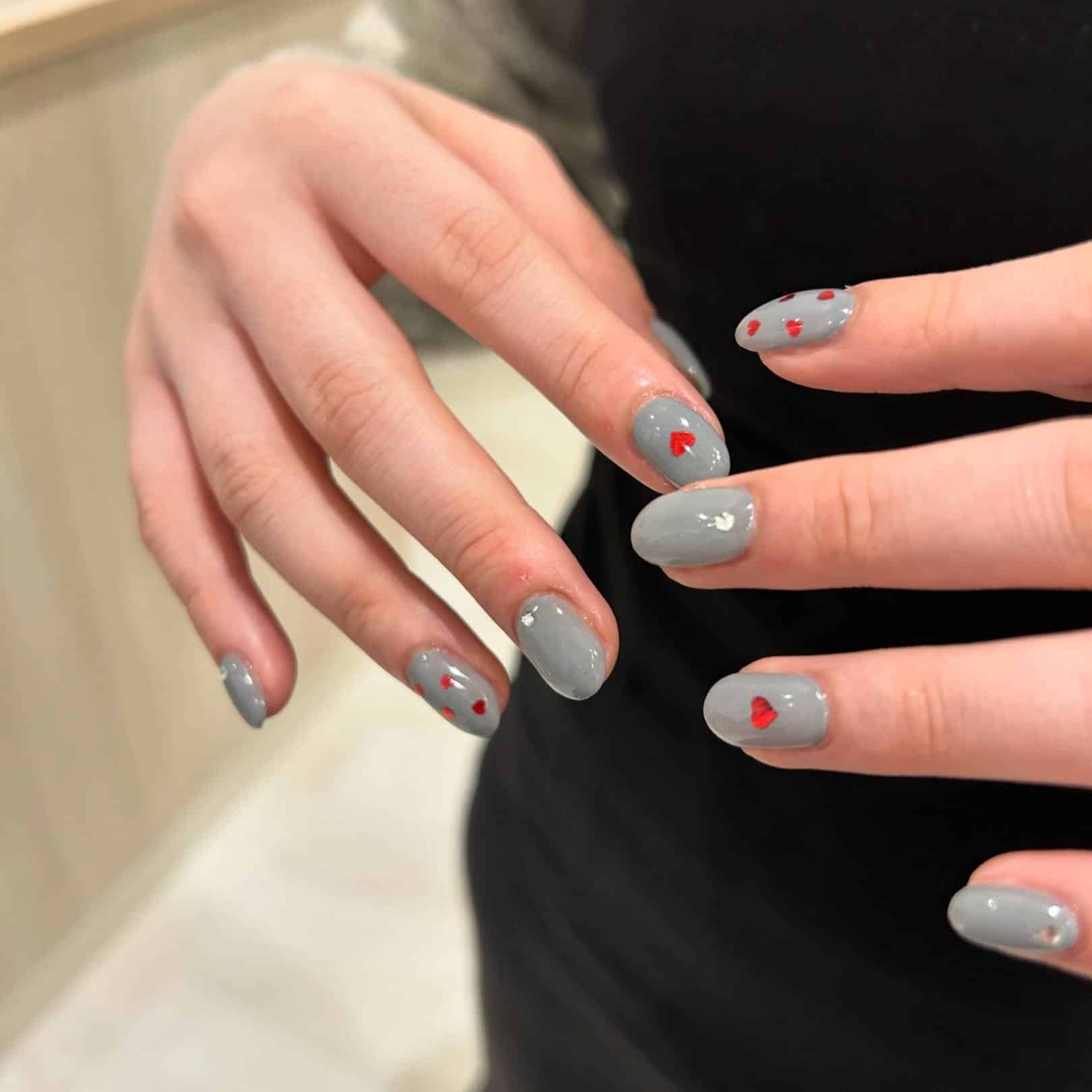 4. Light Gray Nails with Tiny Heart Details - gray nail ideas