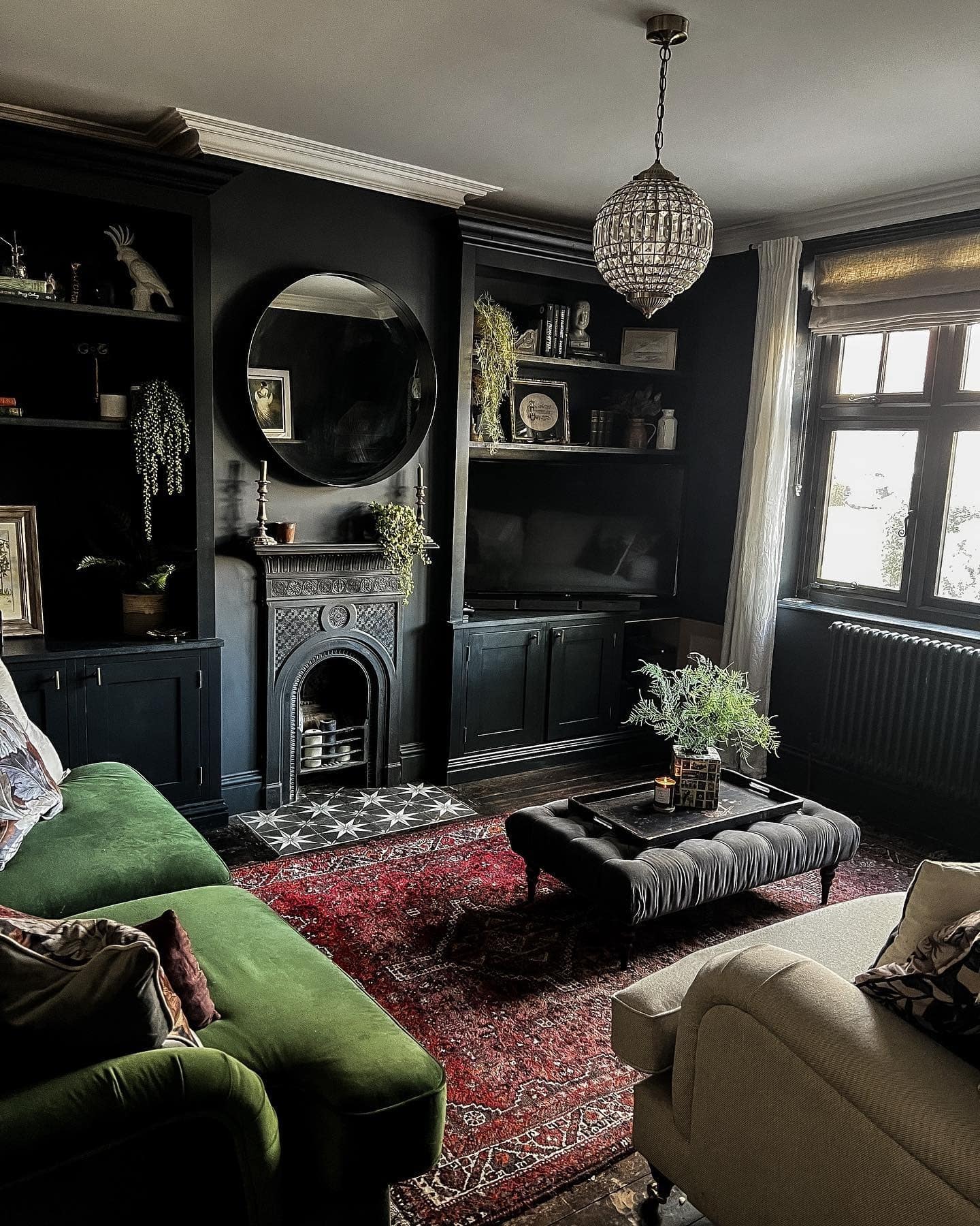 6. Dark Living Room Ideas with Black Built-Ins and Green Sofa - dark living room ideas
