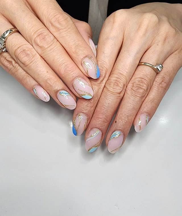 9. Pastel Blue and Gold Flow Line Nails - line nail ideas