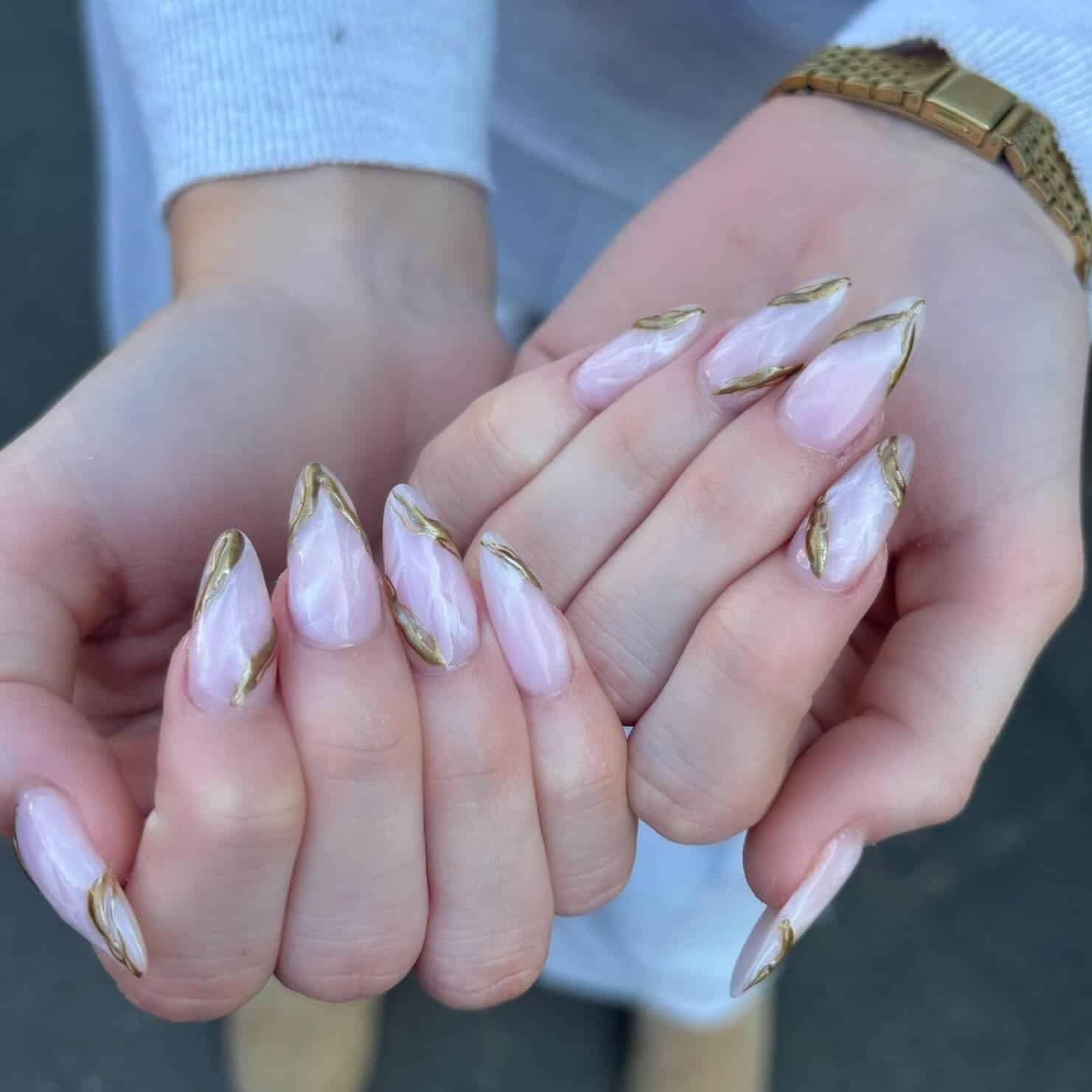 9. Milky White Marble Almond Nails with Gold Edges - marble nail ideas