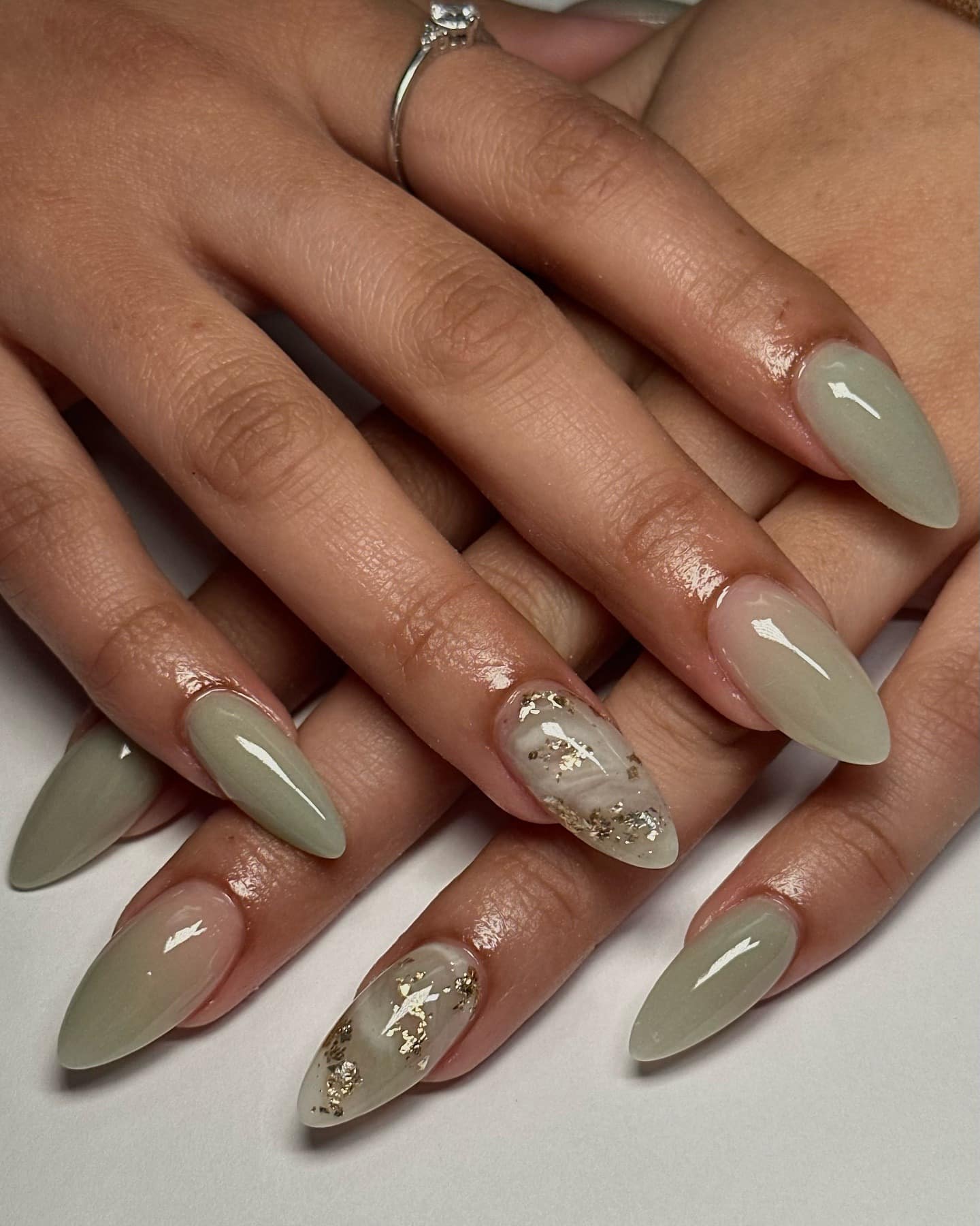 16. Sage Green Almond Marble Nails with Gold Flakes - marble nail ideas