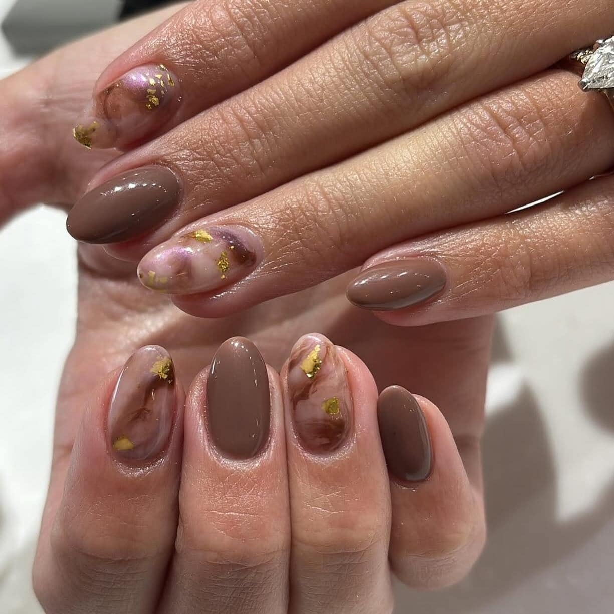 22. Mocha Brown Almond Marble Nails with Gold Foil - marble nail ideas