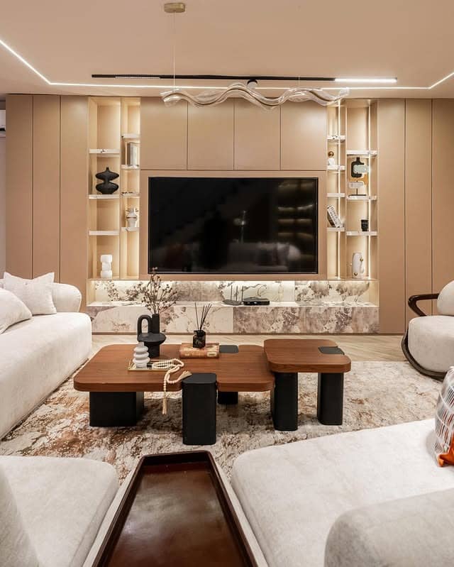 6. Modern Beige Earthy Living Room with Marble TV Wall - earthy living room ideas