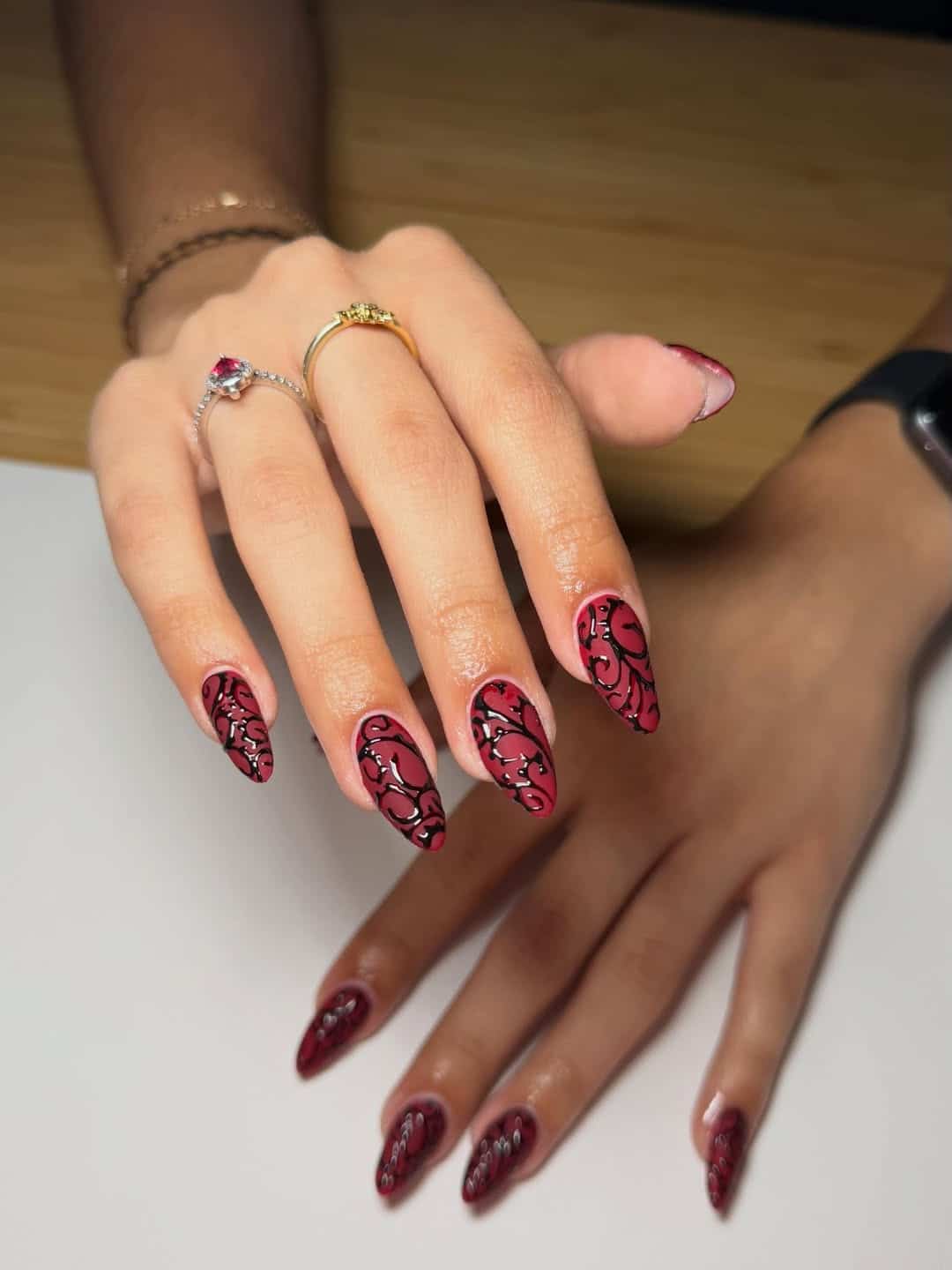 3. Burgundy Swirl Almond Nails - red and black nail ideas