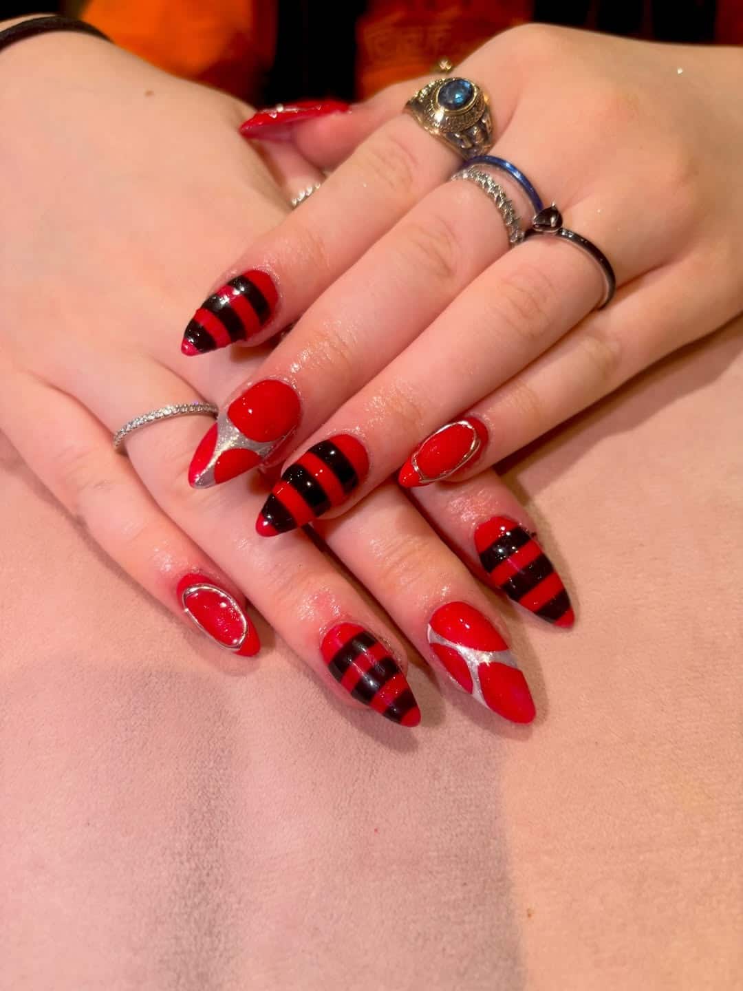 11. Red and Black Striped Almond Nails - red and black nail ideas
