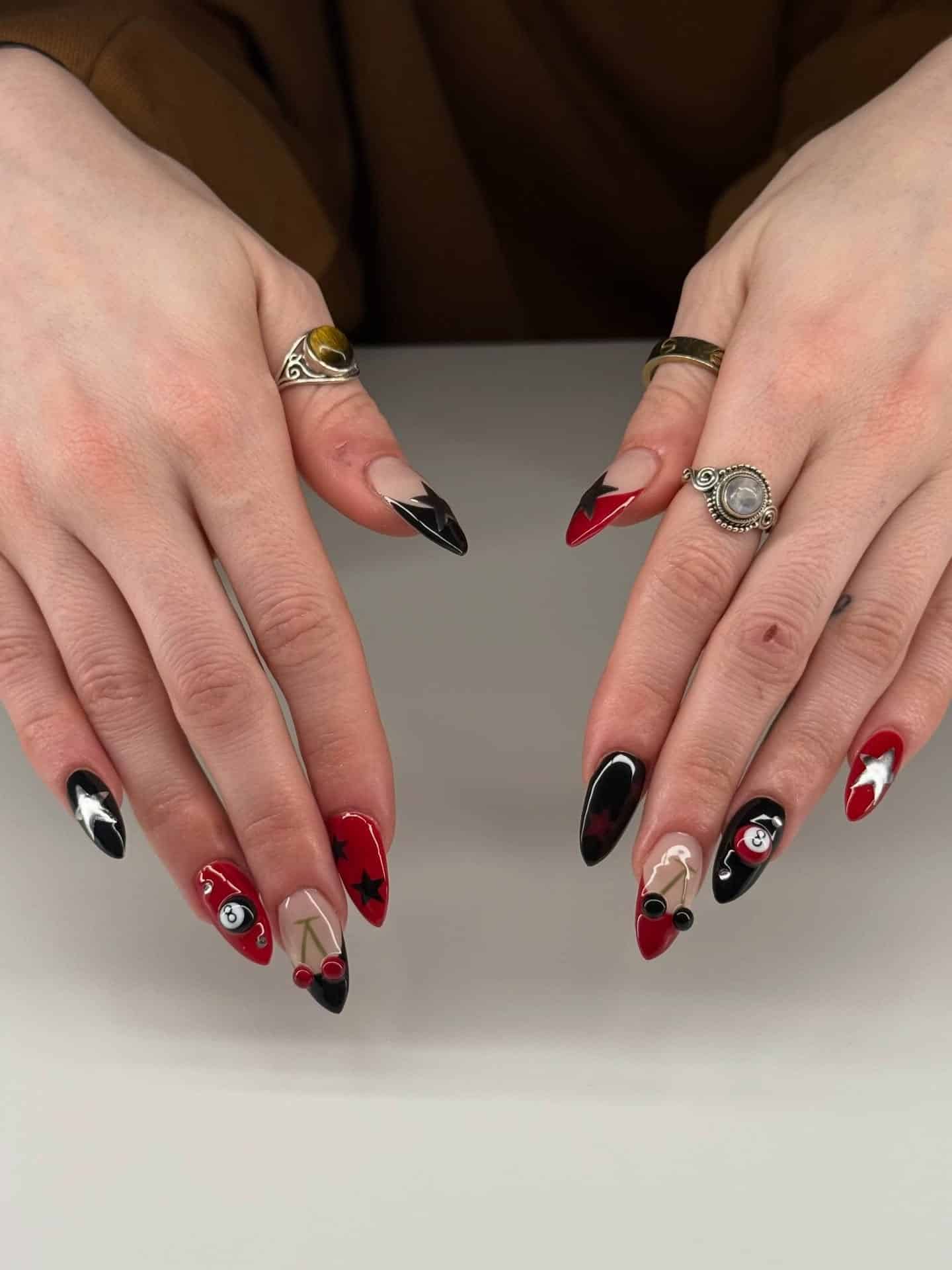 16. Red and Black Graphic Almond Nails - red and black nail ideas