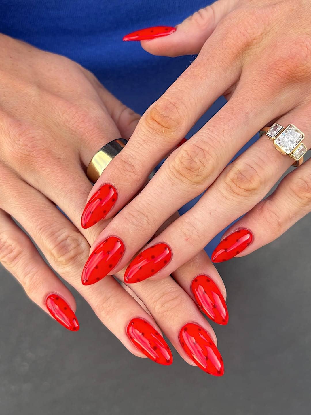 20. Bright Red Almond Nails with Black Speckles - red and black nail ideas