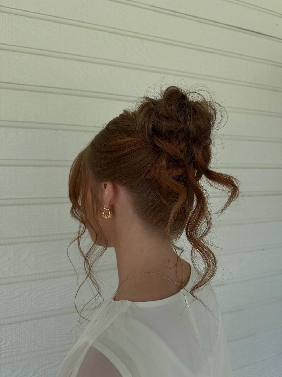10. Soft Auburn Bridal Bun with Wispy Tendrils - Bride Hairstyles