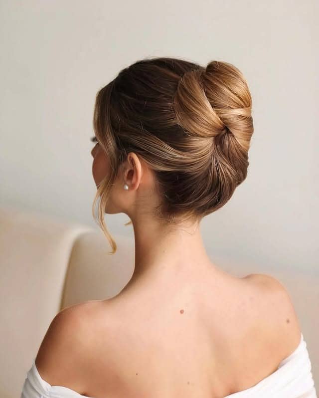 16. Modern Brunette Folded Bridal Bun - Bride Hairstyles