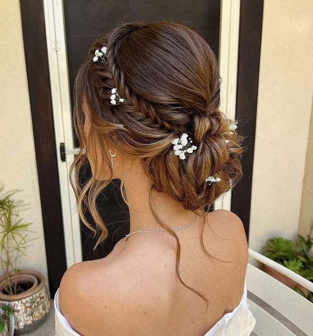 19. Romantic Brunette Floral Low Bun - Bride Hairstyles