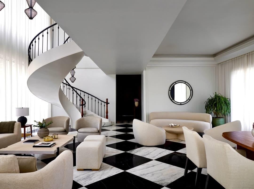 1. Grand Black and White Living Room with Sculptural Staircase - black and white living room ideas