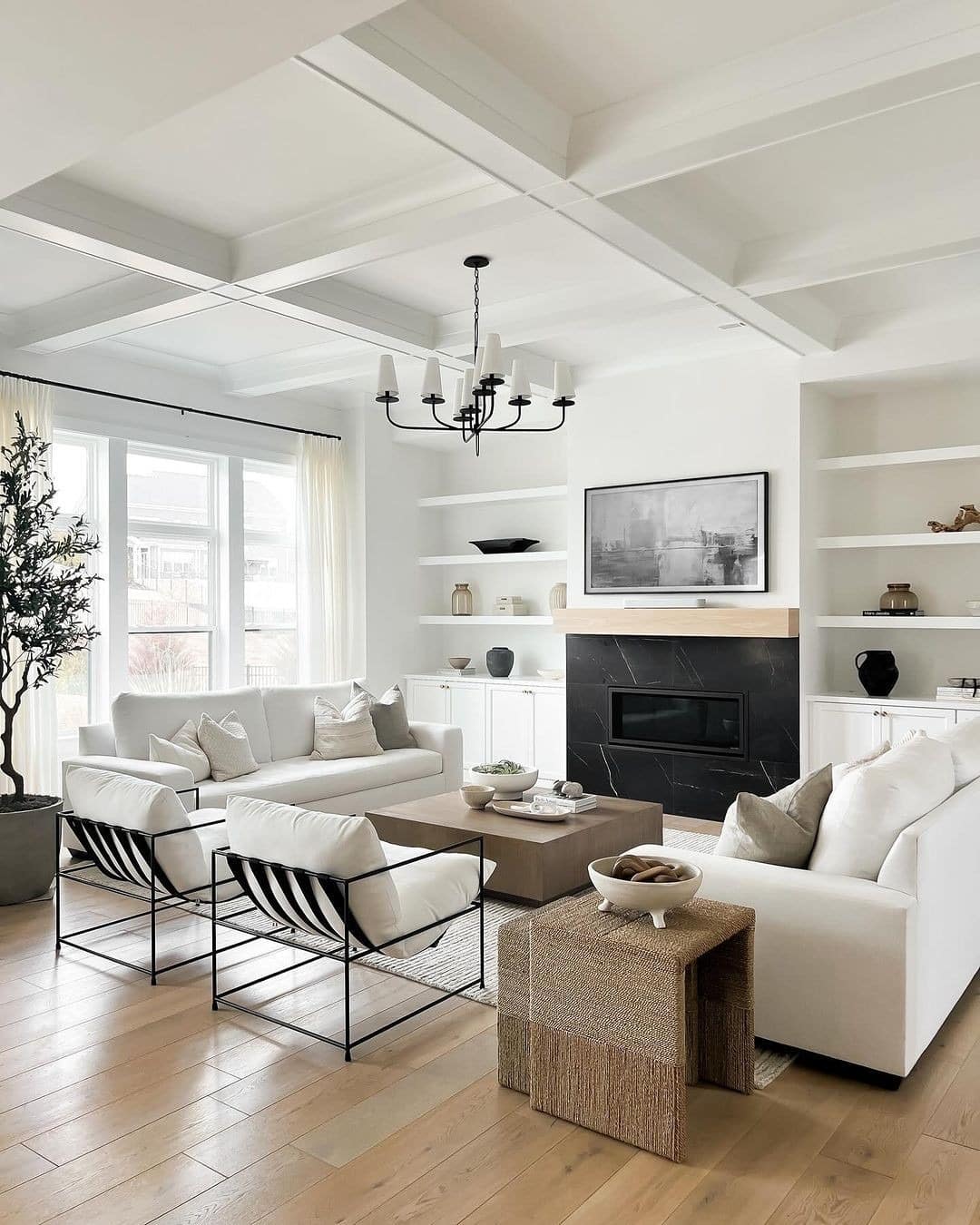 3. Bright Black and White Living Room with Cozy Fireplace - black and white living room ideas