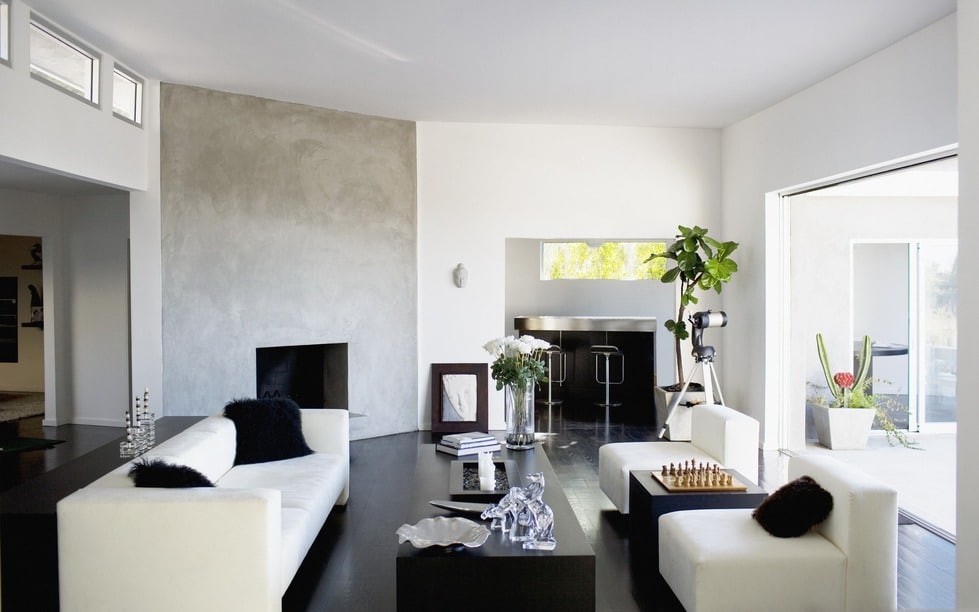 4. Minimalist Black and White Living Room with Concrete Fireplace - black and white living room ideas