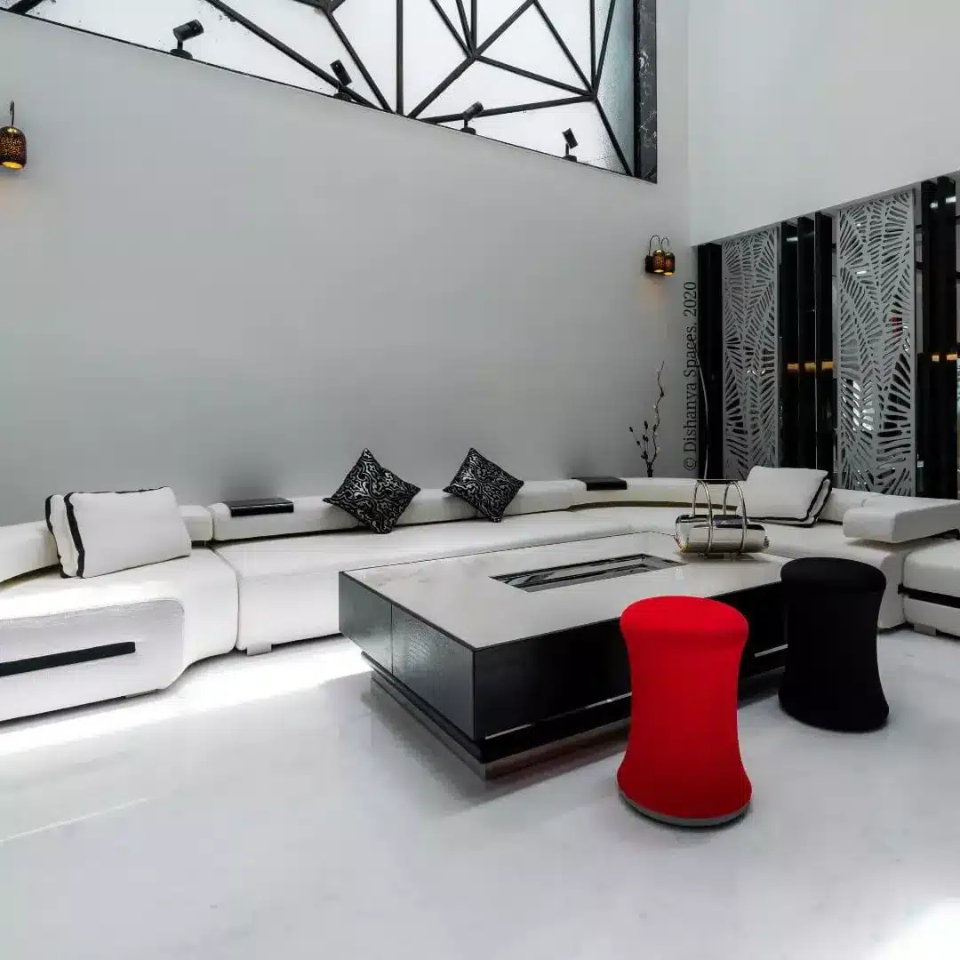 8. Contemporary Black and White Living Room with Bold Accent Seating - black and white living room ideas