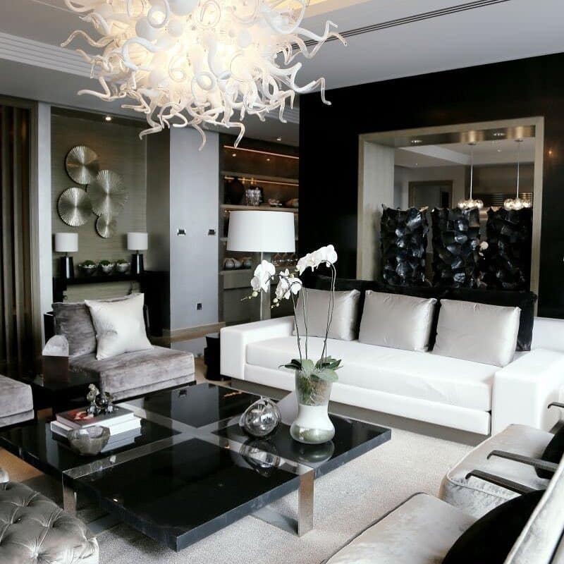 15. Luxe Black and White Living Room with Sculptural Chandelier - black and white living room ideas