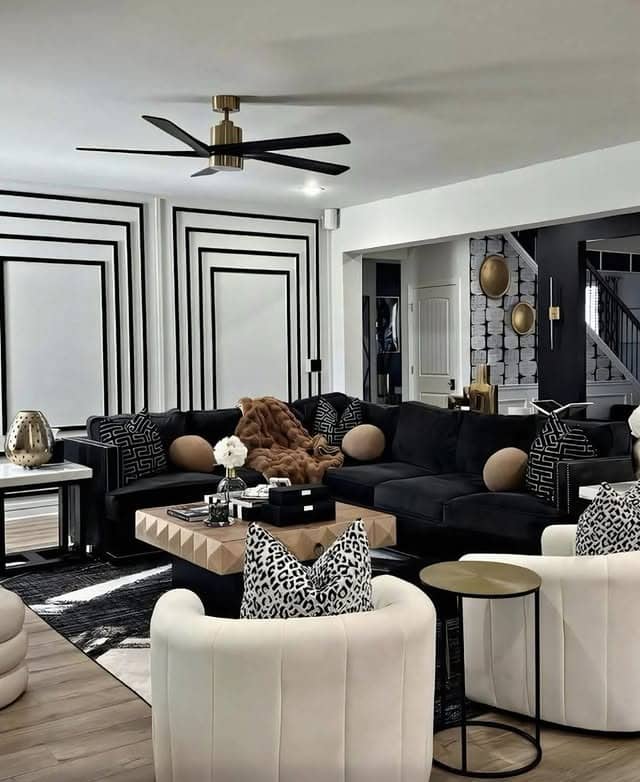 16. Black and White Living Room with Bold Wall Molding - black and white living room ideas