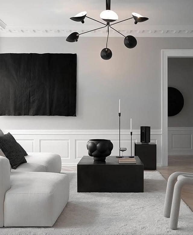 19. Elegant Black and White Living Room with Modern Lighting - black and white living room ideas