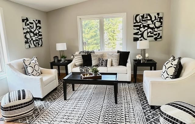 20. Cozy Black and White Living Room with Patterned Area Rug - black and white living room ideas