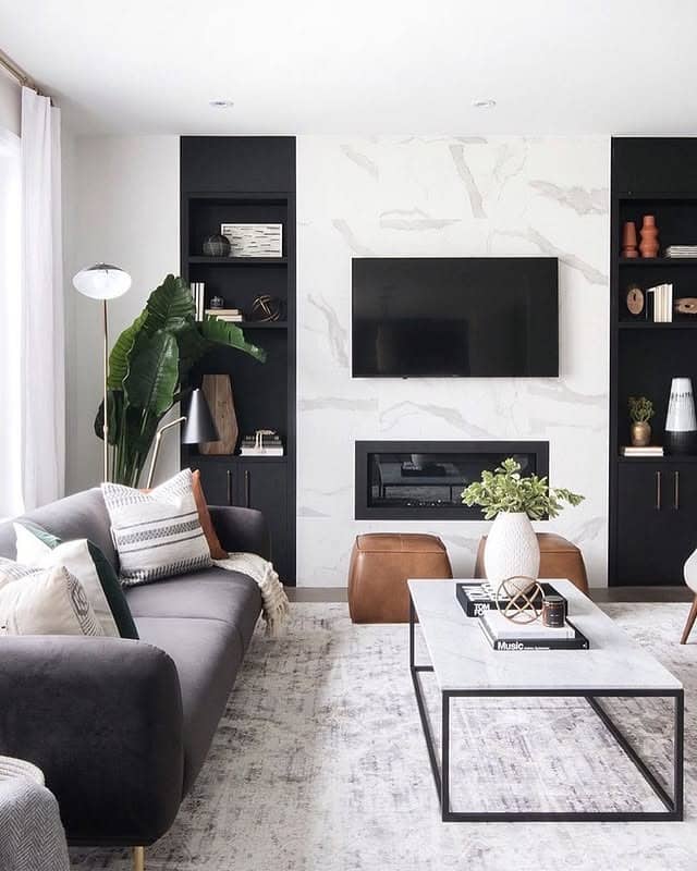 21. Modern Black and White Living Room with Marble Fireplace Wall - black and white living room ideas