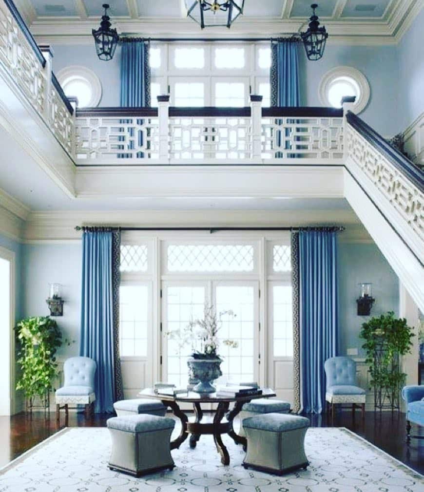 12. Grand Blue and Gray Living Room with Classic Staircase Design - blue and gray living room ideas