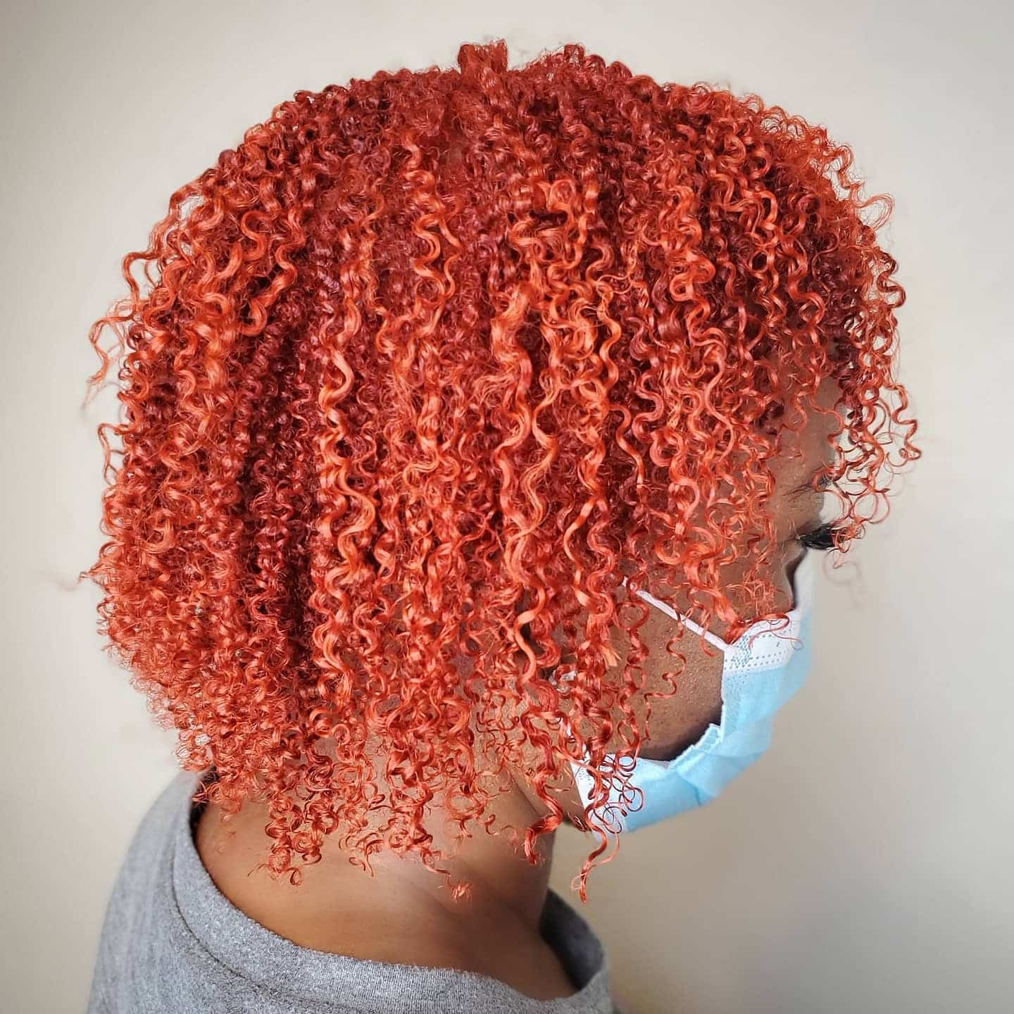 1. Vibrant Red Orange Curly Bob - Red Orange Hair Color