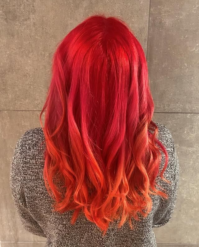13. Vivid Cherry Red Orange Waves - Red Orange Hair Color