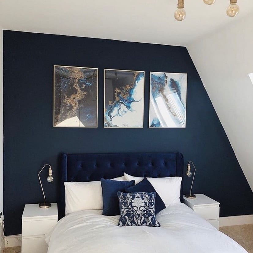 22. Navy Blue Accent Wall Bedroom with Modern Art - navy blue bedroom ideas