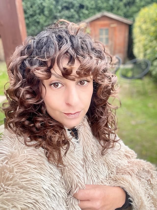 18. Chocolate Brown Curly Shag with Baby Bangs - 80S Hairstyles