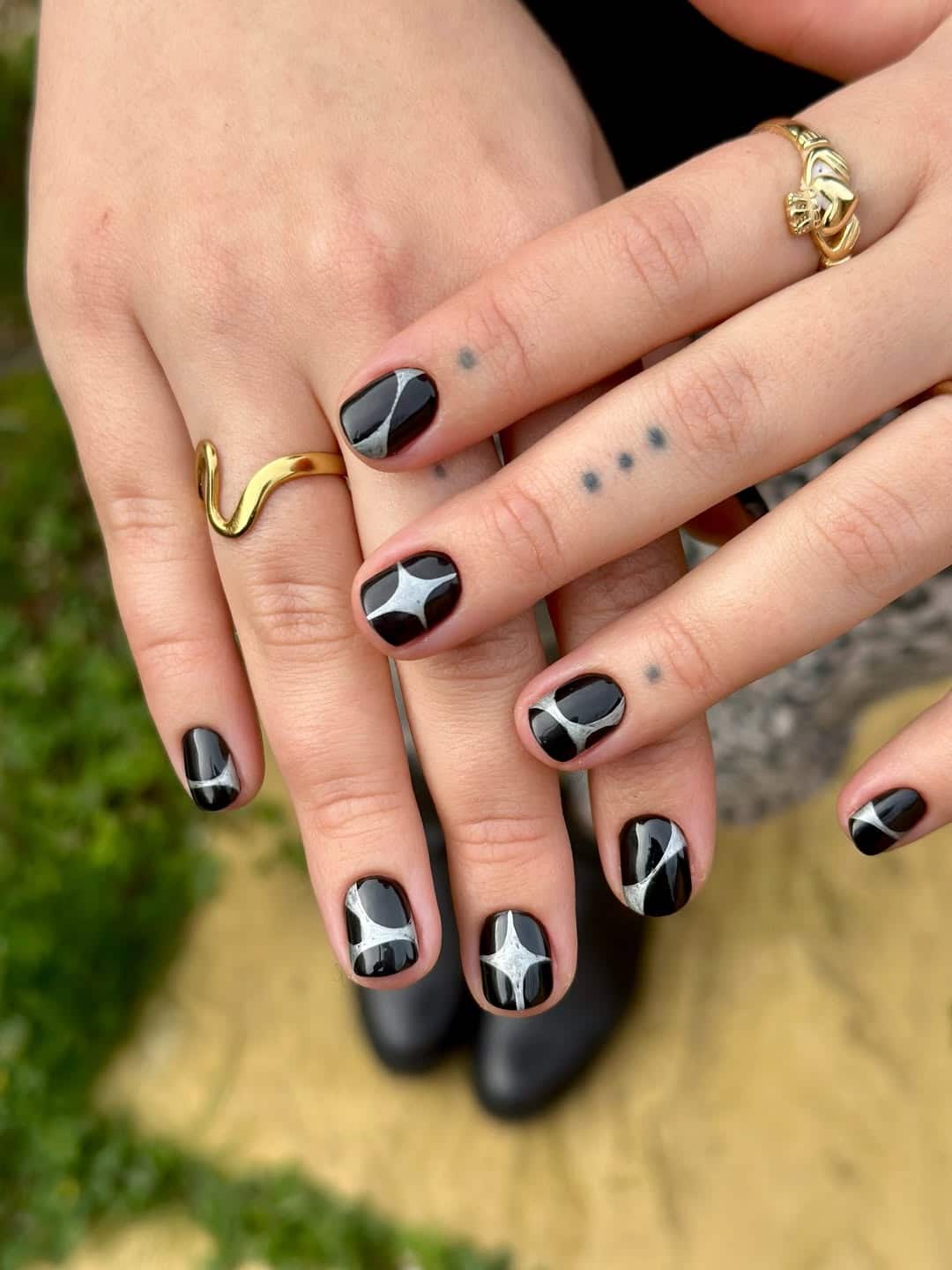 2. Short Black Nails with Silver Star Accents - short black nail ideas