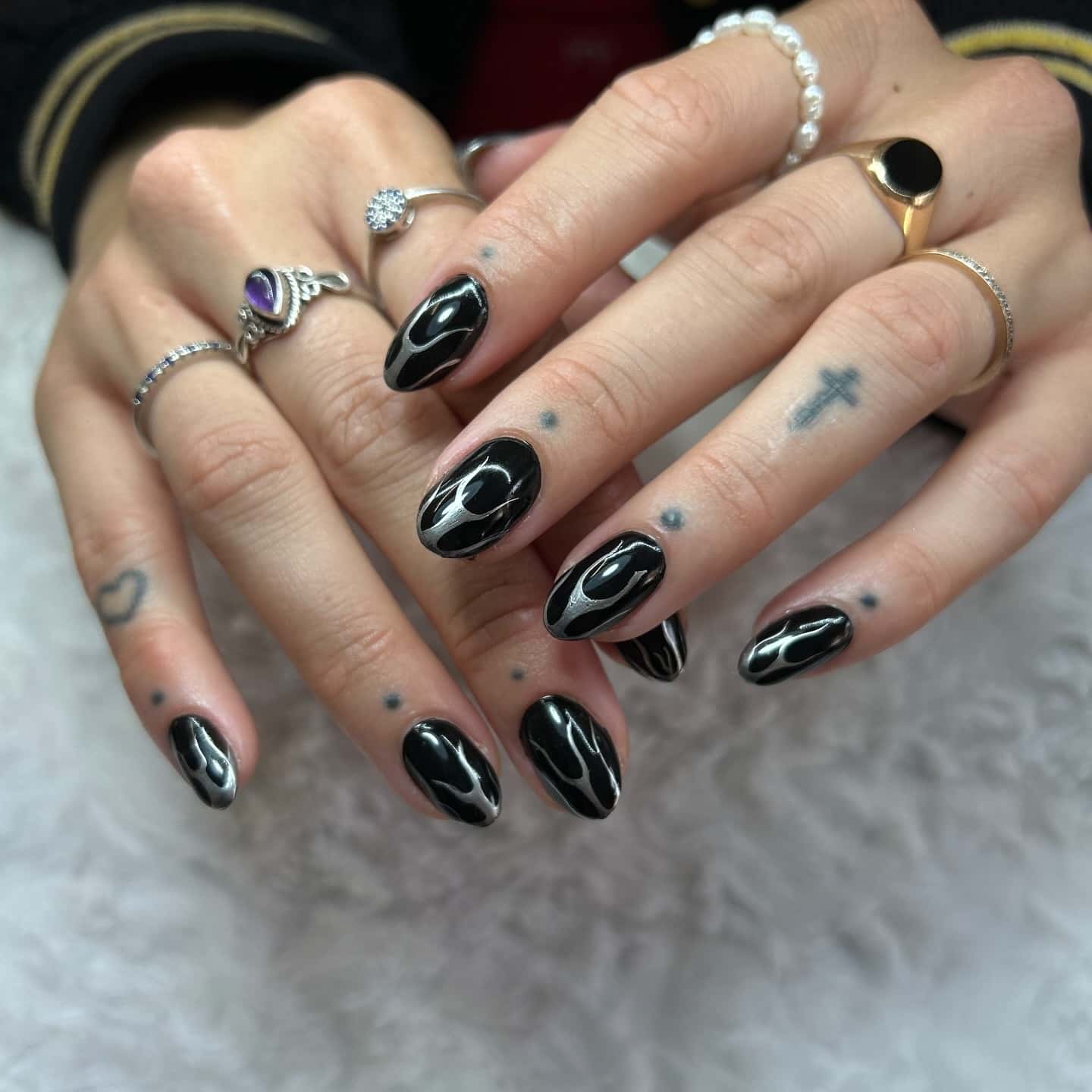 6. Black Chrome Swirl Almond Nails - short black nail ideas