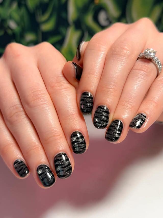 18. Short Black Glitter Zebra Nails - short black nail ideas