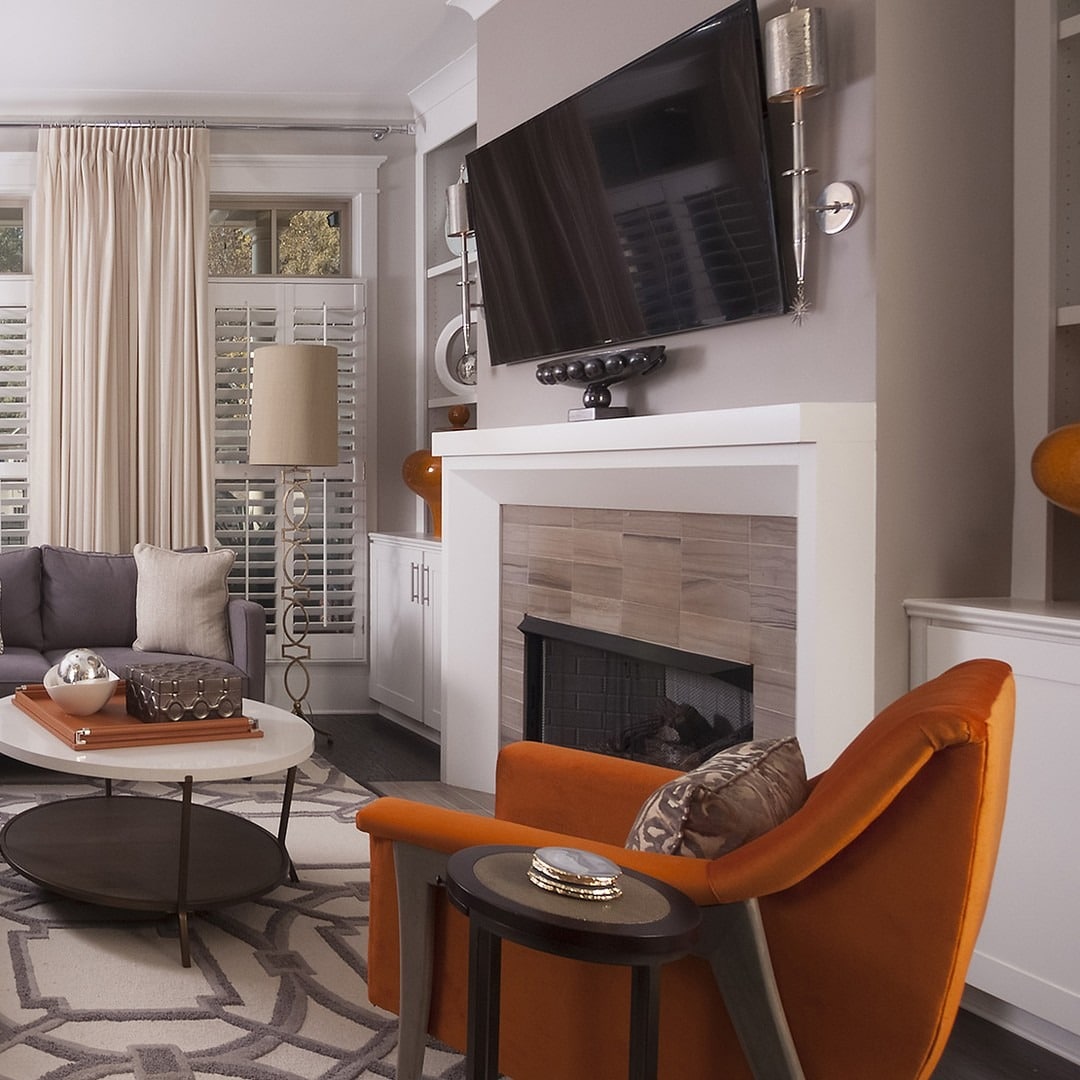 11. Orange Accent Chair and Gray Fireplace Living Room Idea - orange and gray living room ideas