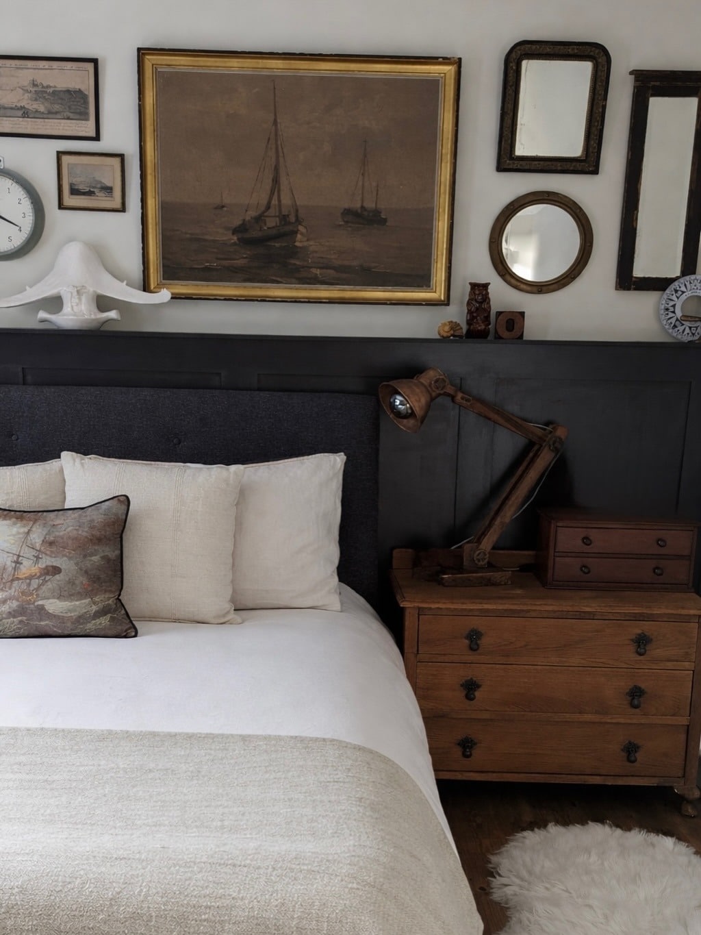 15. Vintage Nautical Bedroom Idea with Dark Wood and Antique Art - nautical bedroom ideas