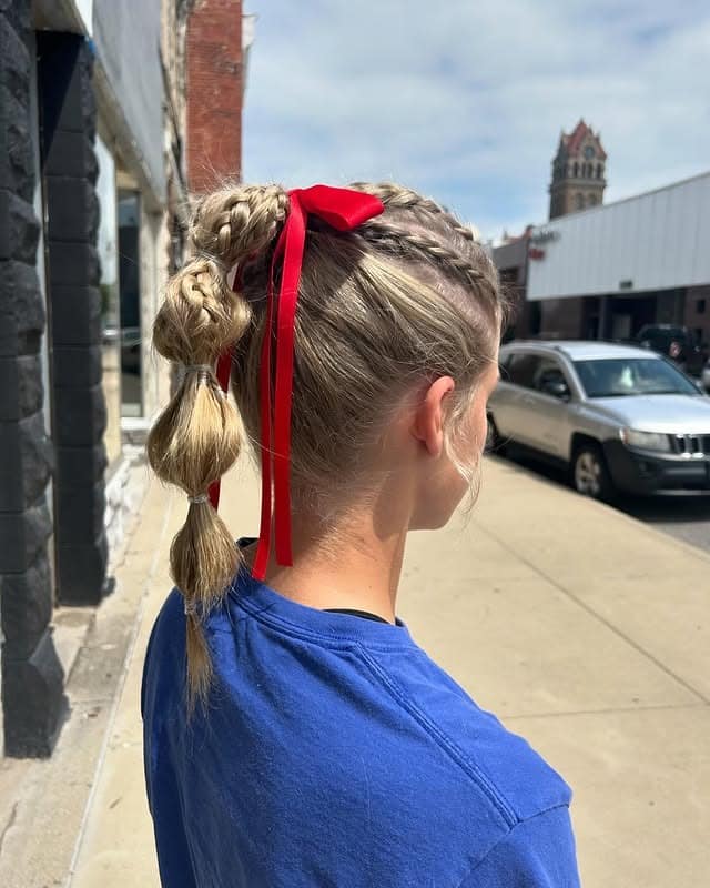 15. Braided Bubble Ponytail with Red Ribbon on Dark Blonde Hair - Volleyball Hairstyles