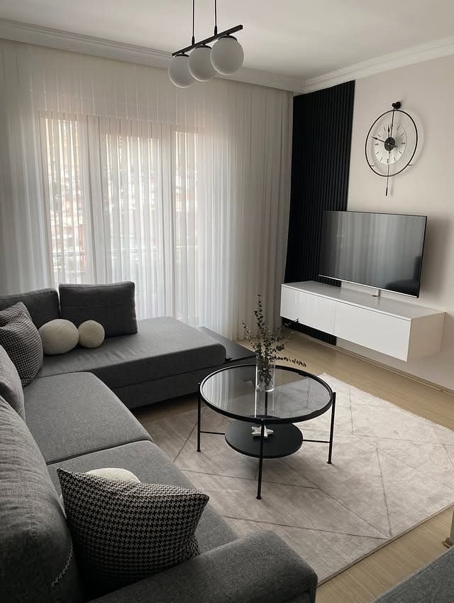 3. Modern Grey and White Living Room with Sleek TV Wall - grey and white living room ideas