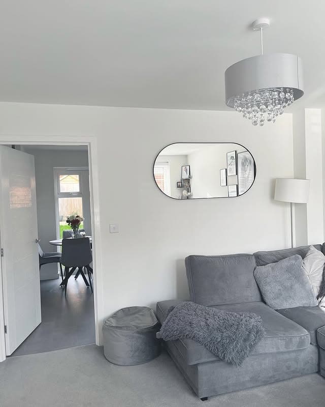 18. Elegant Grey and White Living Room with Crystal Lighting - grey and white living room ideas