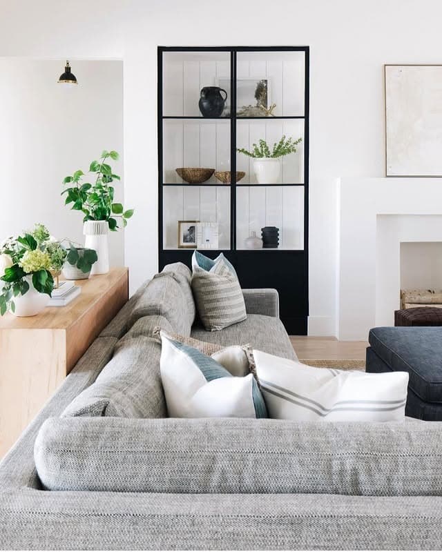 19. Scandinavian Grey and White Living Room with Open Shelving - grey and white living room ideas