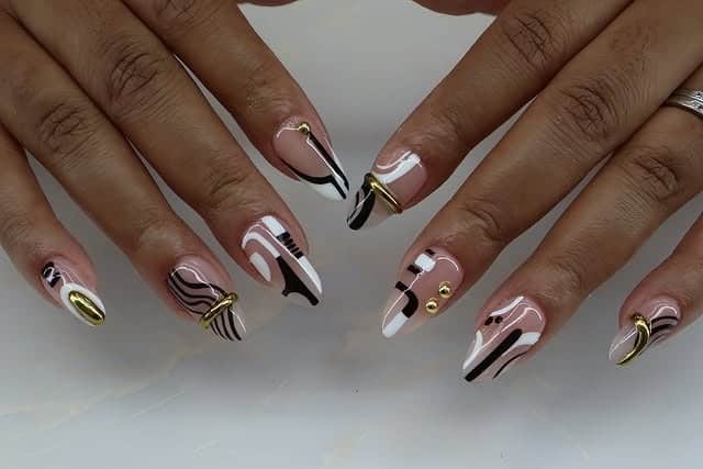 19. Black and White Abstract Stiletto Nails with Gold Accents - abstract nail ideas