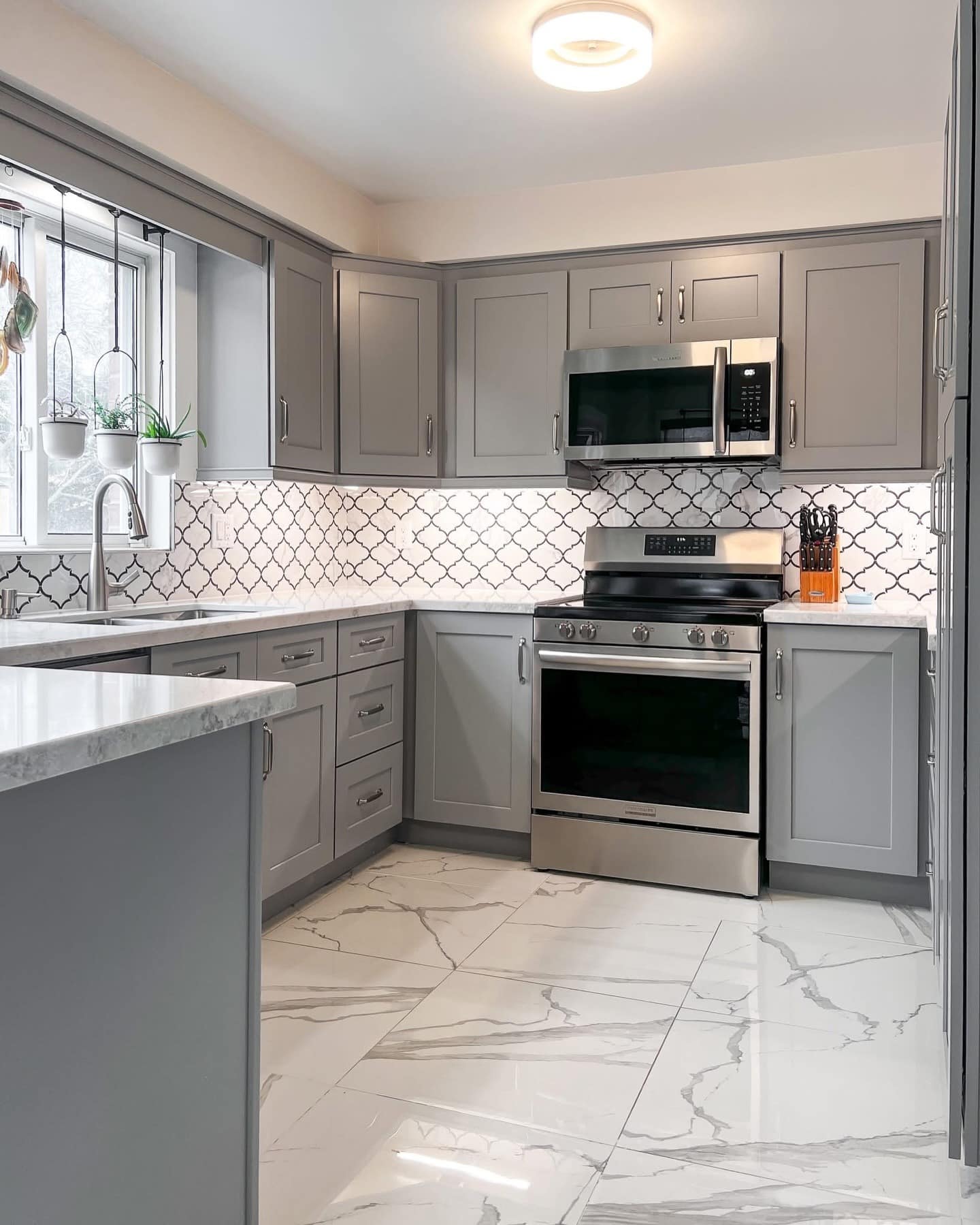 9. Light Gray Kitchen Cabinets with Patterned Backsplash - gray kitchen cabinet ideas