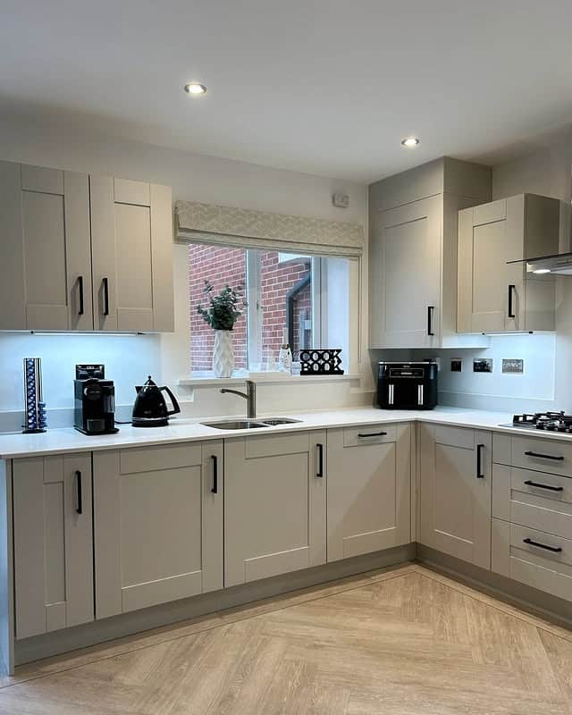 14. Warm Gray Kitchen Cabinets with Matte Black Hardware - gray kitchen cabinet ideas