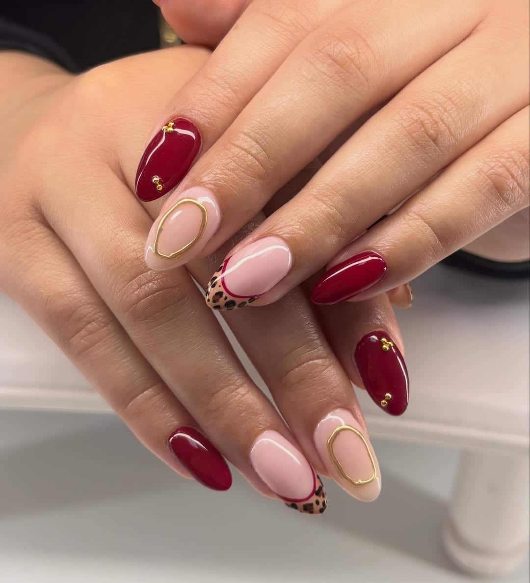 19. Burgundy Almond Nails with Leopard Accent Art - birthday nail ideas