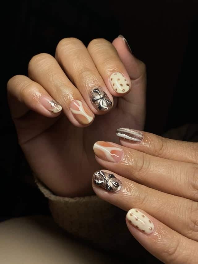 21. Neutral Abstract Short Nails with Chrome Bow Accent - birthday nail ideas