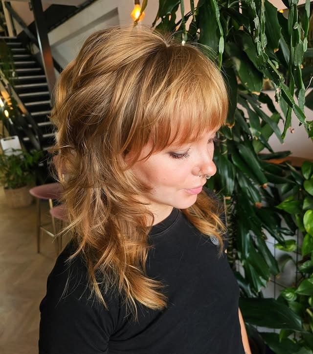 9. Honey Blonde 70s Wolf Cut with Curtain Bangs - 70S Hairstyles