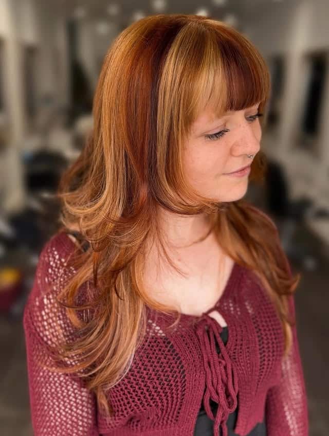 14. Auburn and Golden Blonde 70s Layered Cut with Full Bangs - 70S Hairstyles